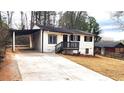 Inviting exterior view of a home with a covered parking area and freshly landscaped yard at 2232 Addison Nw Pl, Atlanta, GA 30318