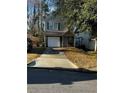 Charming two-story home featuring a front yard, driveway, and attached garage at 3523 Lehigh Way, Decatur, GA 30034