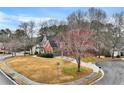 Traditional two-story home with brick accents, a two car garage and a landscaped front yard at 5712 Overlook Cir, Powder Springs, GA 30127