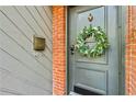 Charming front door adorned with a wreath, set against a brick and gray exterior with a mailbox at 1600 Briarcliff Ne Rd # 5, Atlanta, GA 30306