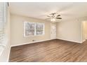 Bright living room featuring modern flooring, a ceiling fan, and natural light at 3169 Bluebird Ln, Decatur, GA 30032