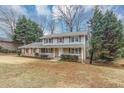 Charming two-story home with brick and siding, shutters, a covered front porch, and a well-manicured front yard at 4481 Buckingham Cir, Decatur, GA 30035