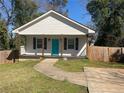 Beautiful home boasts a manicured lawn, inviting walkway and a brightly colored front door at 937 Camilla Sw St, Atlanta, GA 30314