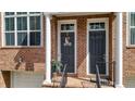 Inviting townhouse front entrance featuring brick facade, and classic details at 1583 Mosaic Way, Smyrna, GA 30080