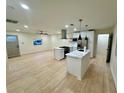 Open-concept kitchen with modern white cabinets, stainless steel appliances, and hardwood floors at 2371 Cresta Dr, Decatur, GA 30032