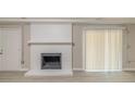 Basement features a painted brick fireplace, and sliding doors leading to the outside at 5845 Highway 92, Fairburn, GA 30213