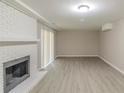 Basement features a painted brick fireplace, and sliding doors leading to the outside at 5845 Highway 92, Fairburn, GA 30213
