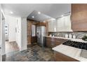 Modern kitchen featuring stainless steel appliances, stone counters, and exposed brick, perfect for culinary enthusiasts at 1116 Piedmont Ne Ave # 12, Atlanta, GA 30309