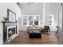 Bright living room with fireplace, hardwood floors, and large windows overlooking the city at 1116 Piedmont Ne Ave # 12, Atlanta, GA 30309