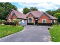 Stunning brick home featuring an attached garage, well-manicured lawn and an inviting driveway at 477 Glouchester Dr, Locust Grove, GA 30248