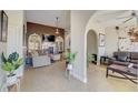 Cozy living room with a fireplace, plush seating, and arched doorway at 477 Glouchester Dr, Locust Grove, GA 30248