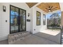 Inviting front porch with wooden ceiling, stylish lighting fixtures, and double glass front doors at 1857 Defoor Ave, Atlanta, GA 30318