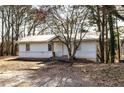 Charming home featuring a white exterior, a metal roof, and a simple entryway surrounded by mature trees at 251 Killian St, Canton, GA 30114