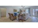 Cozy living room with a fireplace, comfortable seating, and lots of natural light at 220 Nicklaus Cir, Social Circle, GA 30025