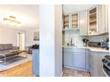 Well-lit kitchen featuring gray cabinets, a tiled backsplash, and stainless steel appliances at 300 W Peachtree St # 10D, Atlanta, GA 30308