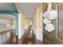 Bright foyer with hardwood floors, wainscoting, and arched doorways leads to open living spaces at 6615 Grove Meadows Ln, Cumming, GA 30028
