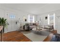 Sun-filled living room with hardwood floors, neutral tones, and ample natural light at 1600 Temple Ave, Atlanta, GA 30337