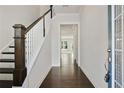 Inviting hallway with hardwood floors, wooden staircase, and neutral walls, leading to the living spaces at 1891 Audubon Park Ln, Decatur, GA 30033
