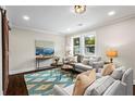 Cozy living room showcasing two sofas, a decorative rug, and lots of natural light at 253 Mcintosh Avenue Ne, Marietta, GA 30060