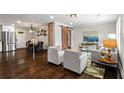 Spacious living room featuring an open floor plan, hardwood floors, and a sliding barn door at 253 Mcintosh Avenue Ne, Marietta, GA 30060