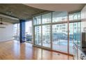 A living room featuring floor-to-ceiling windows with a balcony overlooking a pool at 923 Peachtree Ne St # 932, Atlanta, GA 30309
