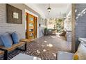 Relaxing front porch with seating, a swing, tiled flooring, and exposed brick at 996 Blue Ridge Ne Ave, Atlanta, GA 30306