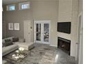 Bright living room features a stone fireplace, modern decor, and ample natural light at 1920 Moores Mill Nw Rd, Atlanta, GA 30318
