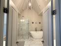 Modern bathroom with freestanding tub and frameless glass shower, offering a luxurious experience at 2021 Towneship Trl, Roswell, GA 30075