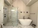Bright bathroom showcases a walk-in shower, soaking tub, and modern fixtures at 2021 Towneship Trl, Roswell, GA 30075