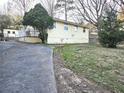 Home exterior with siding, an unfinished yard, and visible foundation at 3254 Howell Cir, Duluth, GA 30096