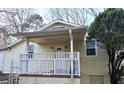 Exterior front porch with white railings and yellow siding at 3254 Howell Cir, Duluth, GA 30096