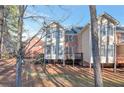 Exterior of a multi-level home with a wooded backyard and a small deck at 572 Vinings Estates Se Dr # B9, Mableton, GA 30126
