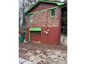 View of a two-story brick building with a garage and green trim at 2765 Rollingwood Se Ln, Atlanta, GA 30316