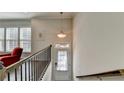 Bright entryway with a pendant light and stairs at 376 Provenance Dr, Atlanta, GA 30328