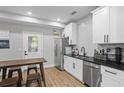 Modern kitchen featuring stainless steel appliances, white cabinets, and stylish tile backsplash at 1174 Princess Sw Ave, Atlanta, GA 30310