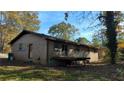 Back view of brick home with deck, yard and mature trees at 868 Maxey Hill Ct, Stone Mountain, GA 30083