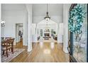 Elegant entryway featuring hardwood floors, arched doorways, and views into the spacious living room at 9435 Grande Dr, Winston, GA 30187