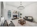 Bright living room with a modern chandelier, fireplace, and plenty of space for entertaining at 9435 Grande Dr, Winston, GA 30187