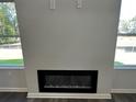 Close-up of a modern fireplace with a sleek black frame and decorative crystals, set against a neutral-colored wall at 45 Heyman Dr, Covington, GA 30016