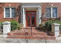 Apartment entrance with brick steps, red doors, and a white pillar framed entryway at 733 Frederica Ne St # 7, Atlanta, GA 30306