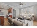 Cozy living room with hardwood floors, ceiling fan, and natural light from large windows at 733 Frederica Ne St # 7, Atlanta, GA 30306