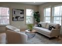 Comfortable living room with neutral furniture, hardwood floors, and natural light from windows at 1395 Winburn Dr, East Point, GA 30344