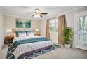 Serene bedroom featuring a ceiling fan, a comfortable bed, and balcony access at 394 Teal Ct, Roswell, GA 30076