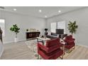 Well-lit living room featuring modern furniture, neutral walls, and a cozy atmosphere with multiple windows at 2776 Aralynn Way, College Park, GA 30337