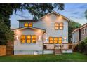This backyard boasts a well-maintained lawn, wood fence, and a charming deck perfect for entertaining at 61 Newcastle Sw St, Atlanta, GA 30314