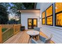Enjoy outdoor dining on this wood deck with comfortable seating and views of the private backyard at 61 Newcastle Sw St, Atlanta, GA 30314