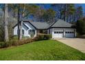 Attractive single-story home featuring a well-manicured lawn, mature landscaping, and a two-car garage at 1190 Saint Ives Ct, Suwanee, GA 30024