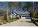 Charming single-story home with a two-car garage, lush landscaping, and a well-kept driveway at 1190 Saint Ives Ct, Suwanee, GA 30024