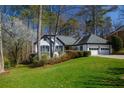 Lovely single-Gathering home with a neat lawn, established landscaping, and an attached two-car garage at 1190 Saint Ives Ct, Suwanee, GA 30024