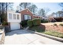 Charming brick home featuring a driveway and lovely landscaping at 1251 Cumberland Ne Rd, Atlanta, GA 30306